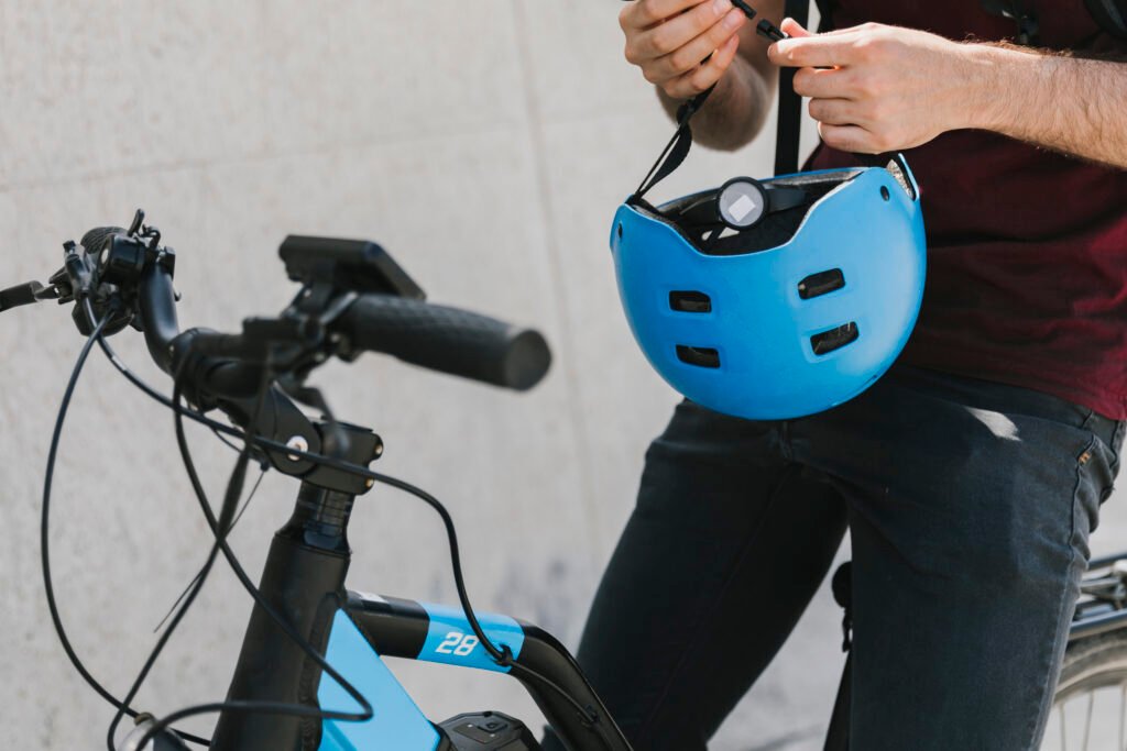 close-up-man-holding-helmet-bicycle New e-bike rider following safety tips in the city