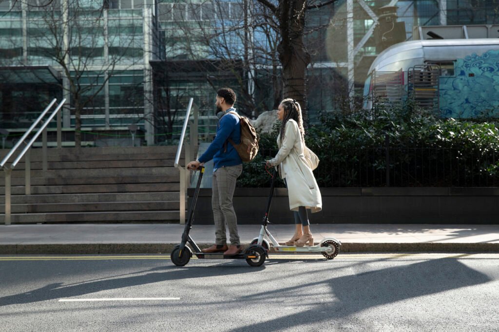 a couple is commuting on e-scooter