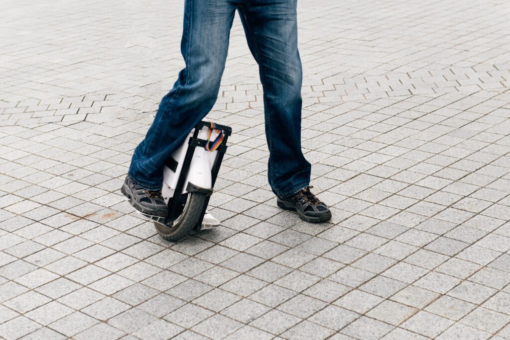 Man riding fast on EUC on city street. Man riding fast on EUC on city street