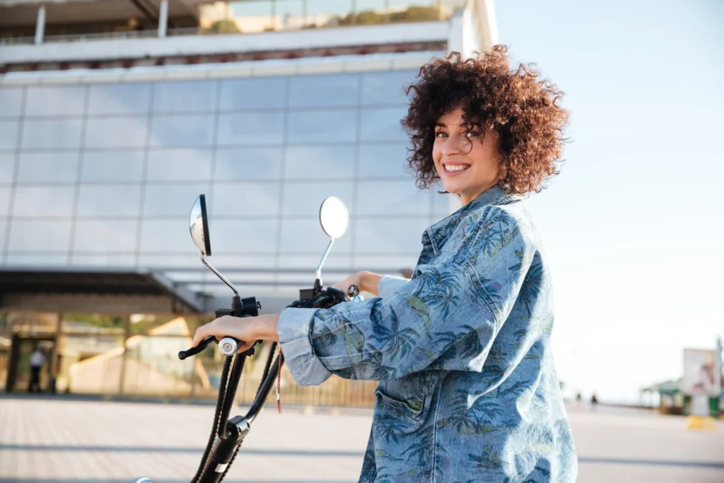 woman-sitting-motorbike-outdoors-scaled Electric mobility illustration with e-bike