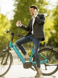 Man riding on his ebike and talking on the phone