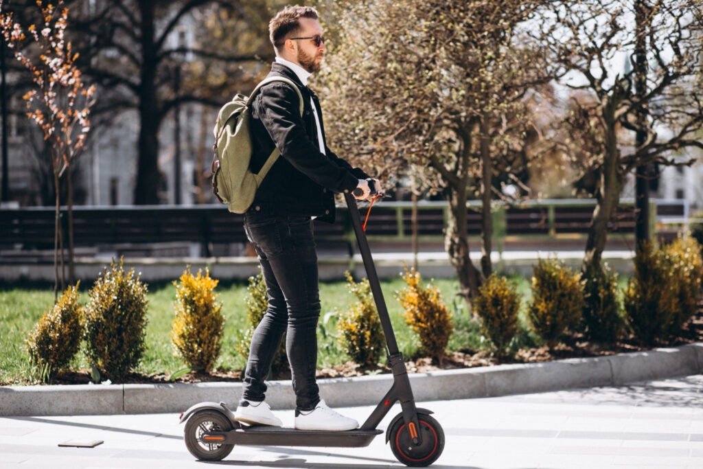 man commuting on his electric scooter Man commuting to work on his electric scooter