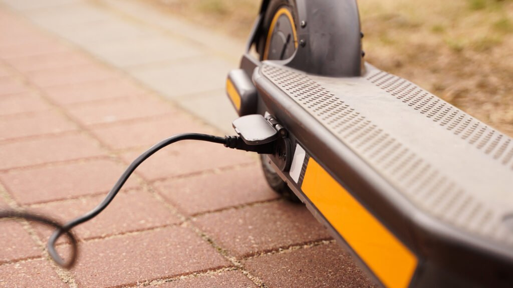 Electric scooter is charging outdoors Electric scooter is charging outdoors