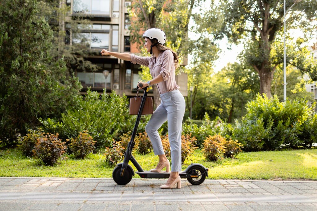 Woman riding electric scooter commuting to work Woman riding electric scooter commuting to work